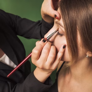 professional-woman-making-up-girl-s-eyes